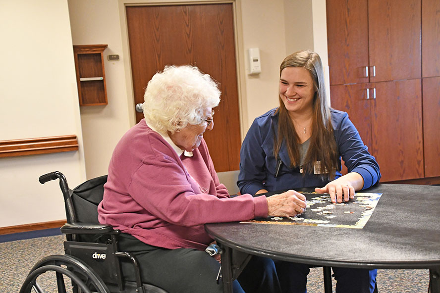 Health professional working with elderly woman