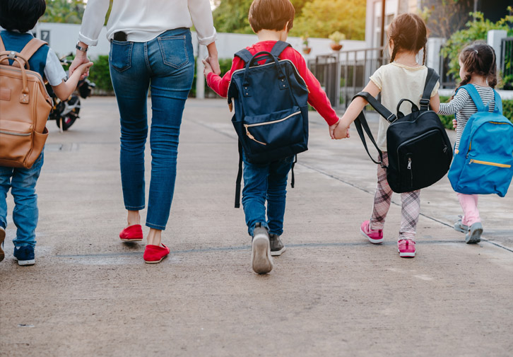 kids walking with mom at back-to-school night