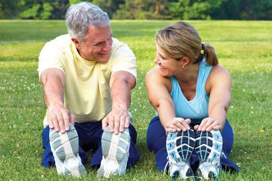 man and woman stretching before exercise in park