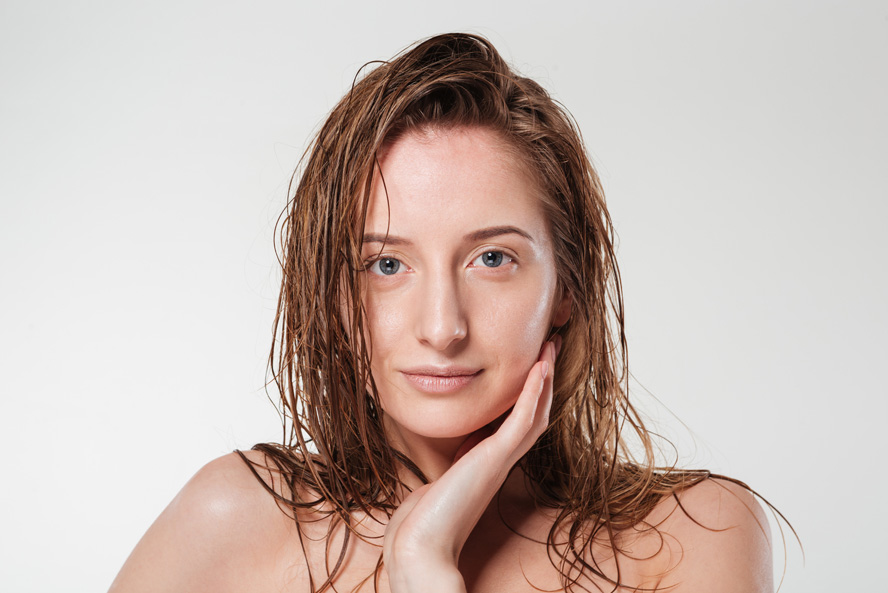 Woman touching face with healthy skin
