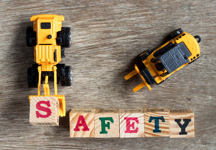toy trucks spelling out safety with blocks